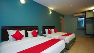 A hotel room with two beds, teal walls, and a red and white bedspread.