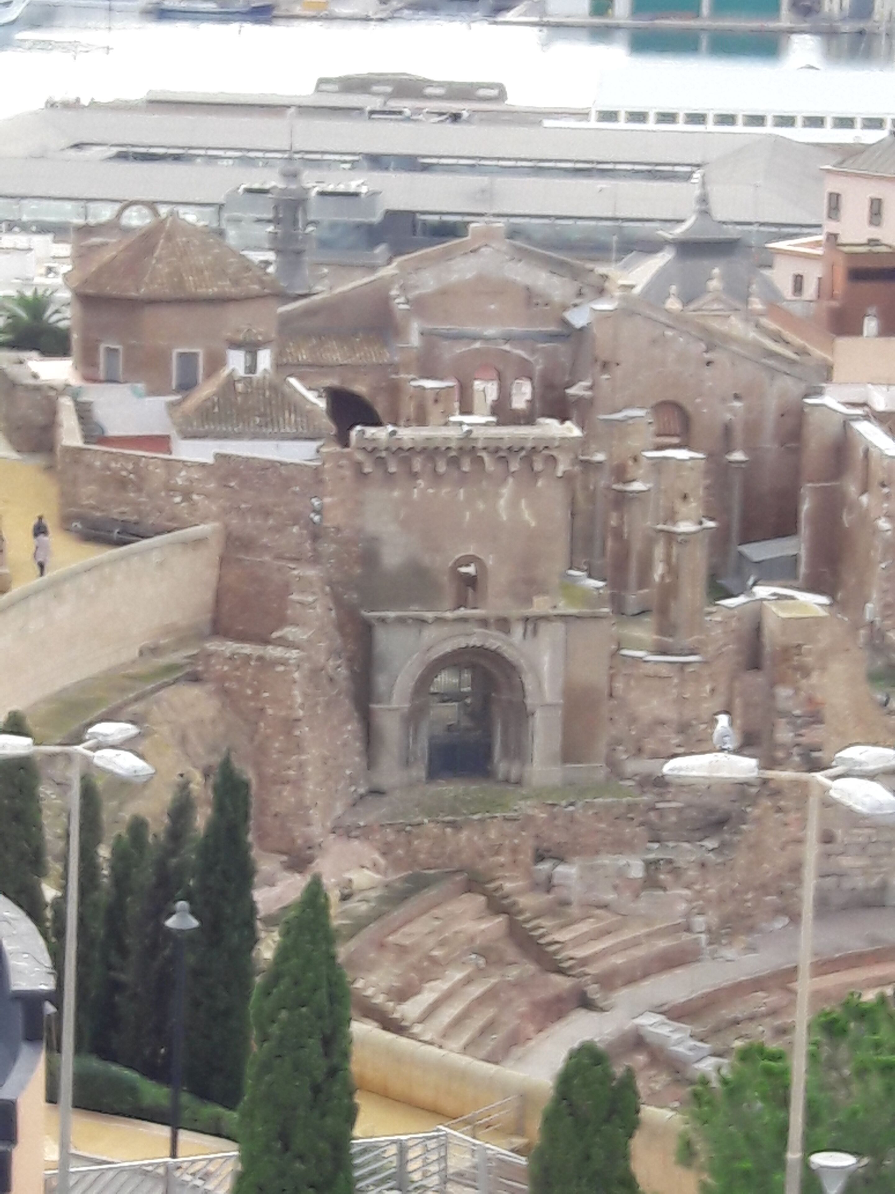 A model of an ancient fortress with a central gate, surrounded by walls and towers.