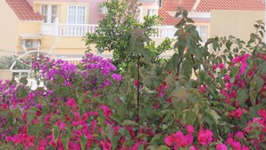 A building with a red-tiled roof and a balcony. - Apartment for rent 5-6 people, Costa Blanca, Orihuela Costa Spain (Orihuela)