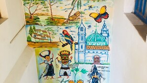A mural with various cultural and natural elements, including a mountain, a church, and indigenous figures. - Apartment in Historic Downtown Quito (Quito)