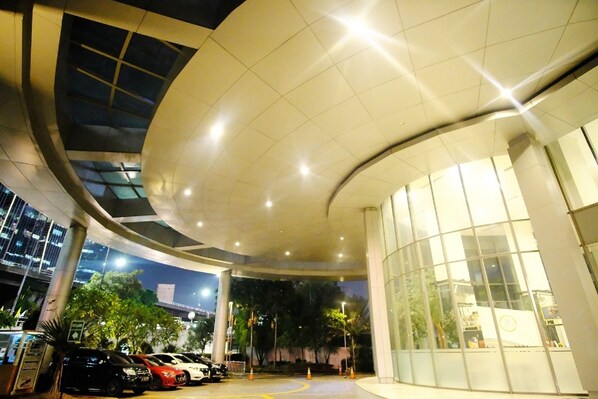 Experience the sleek, modern design of this indoor space with a curved ceiling and expansive windows.