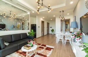Premium Suite, 2 Bedrooms | Living area | 68-inch Smart TV with cable channels, TV, pay films - Rosy Home (Hanoi)