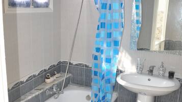 Bathtub, hair dryer, towels, soap