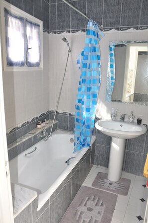 Bathtub, hair dryer, towels, soap