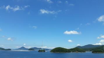 A coastal landscape with multiple islands and a clear blue sky.