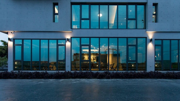 Un bâtiment moderne doté de grandes fenêtres et d’un toit plat.