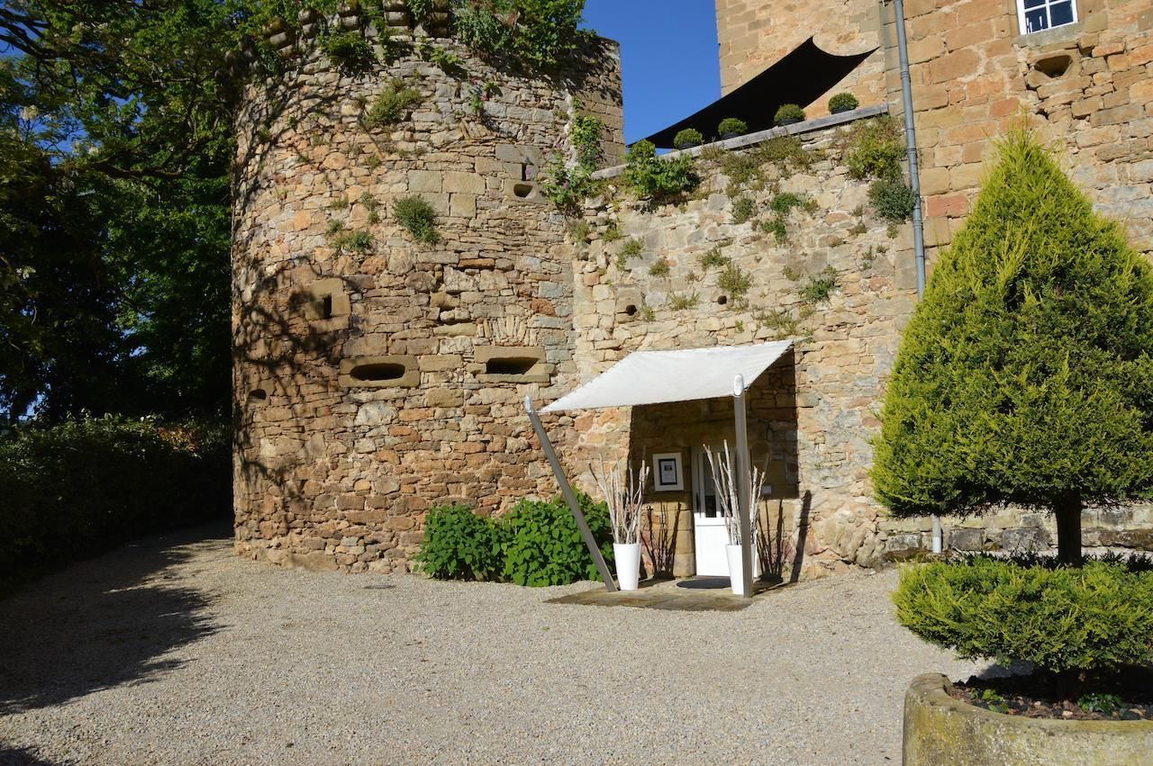 A stone building with a small covered entrance and a well-maintained garden.