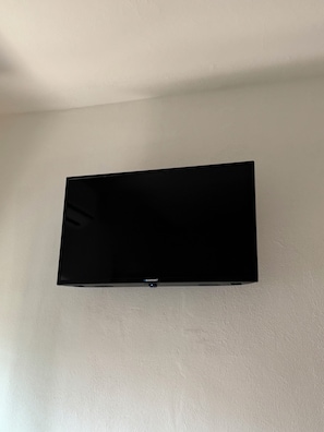 A flat-screen TV mounted on a plain wall.