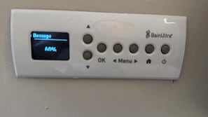 A control panel with a digital display, buttons, and a logo. - Water Hill Gem - Walk to Downtown - Backyard Oasis (Ann Arbor)