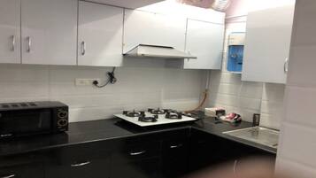 Fridge, microwave, coffee/tea maker, cookware/dishes/utensils