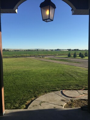 Escape to a serene natural oasis with a beautifully maintained lawn and expansive green fields.
