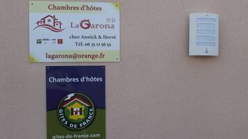 Two signs advertising 'Chambres d'hôtes' with contact information and logos.
