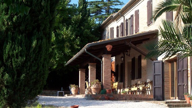 A building with a covered patio, outdoor seating, and a swimming pool. - The Temple at Solebello (Morro D' Alba)