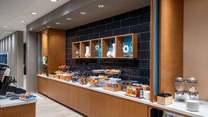A modern breakfast bar with a variety of food items and a refrigerated display. - SpringHill Suites by Marriott St. George Washington (Washington)