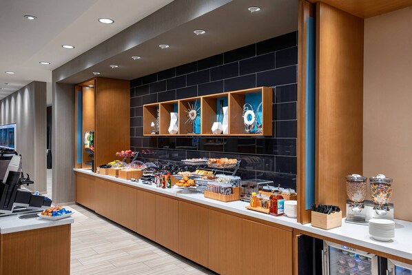 A modern breakfast bar with a variety of food items and a refrigerated display. - SpringHill Suites by Marriott St. George Washington (Washington)