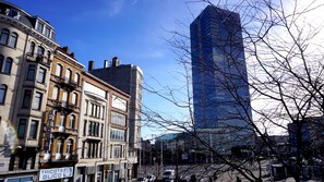 A city street with historic buildings and a modern skyscraper. - Apartments Marco Polo Midi (Brussels)