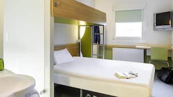 Habitación con literas, una cama individual, un escritorio pequeño, un televisor y una ventana.