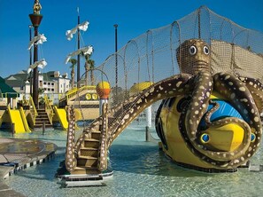 An octopus-themed water play area with slides and a netted enclosure. - 2Br 2Ba @The Gorgeous Sheraton Broadway Plantation RESORT Myrtle Beach  Sleep/8 (Myrtle Beach)