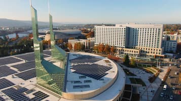 A modern building with a curved roof and solar panels.