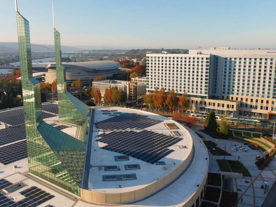 A modern building with a curved roof and solar panels.