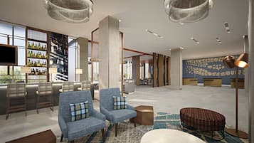 A modern lounge area with seating, a bar, and a large wall with a stone pattern.