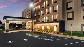 A hotel entrance with clear signage, a parking area with disabled parking spaces, and a well-lit facade. - Hampton Inn Batesville (Batesville)