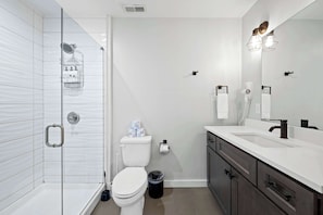 Bathtub, hair dryer, towels, shampoo