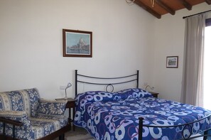 Cozy retreat with a comfortable bed, wooden bench, and framed artwork.