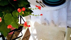 A table set for two with blue plates, a glass, and a small candle. - TIGLI APARTMENT NEAR VENICE (Noale)