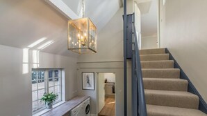 A laundry area with a washing machine, a drying rack, and a hanging clothes rack. - Marsh Lodge, Aldeburgh (Aldeburgh)