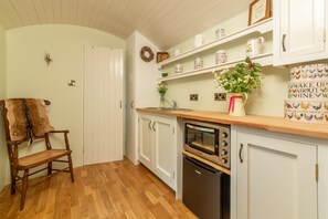 The kitchen complete with fridge, electric combination cooker and sink