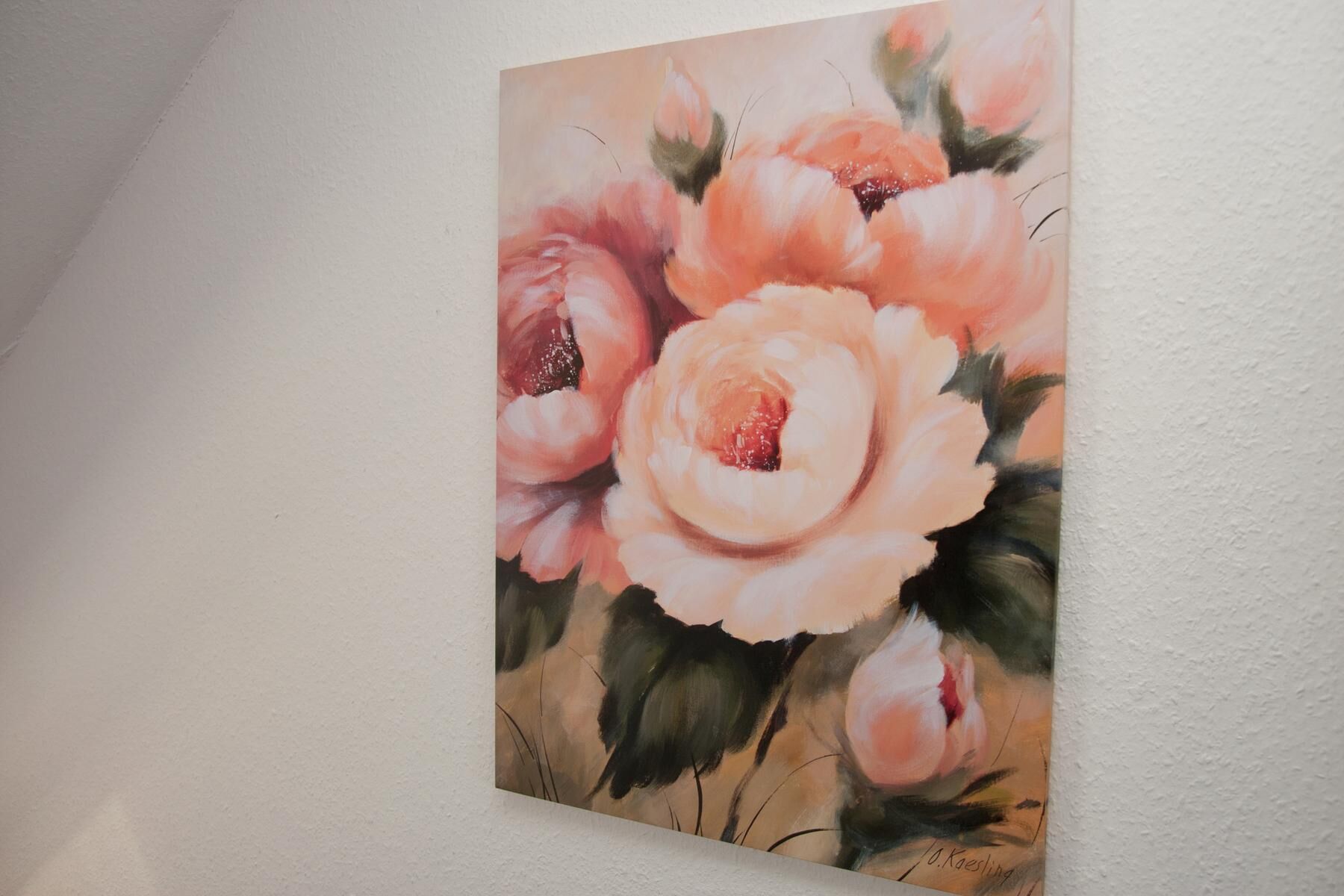 A painting of flowers on a wall.