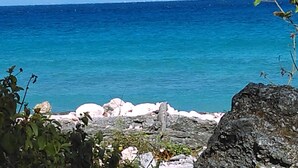 A rocky shoreline with clear blue water. - Studio Kin.  Close to Beaches, diving and Island Attractions. Paradise found. (Cozumel)