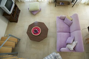 Relax in this stylish living room with a sofa, coffee table, and mounted TV.