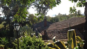 A rustic building with a tiled roof, surrounded by lush greenery and cacti. - Casanatura Capo Mulini, traditional Sicilian rustic surrounded by nature (Acireale CT)