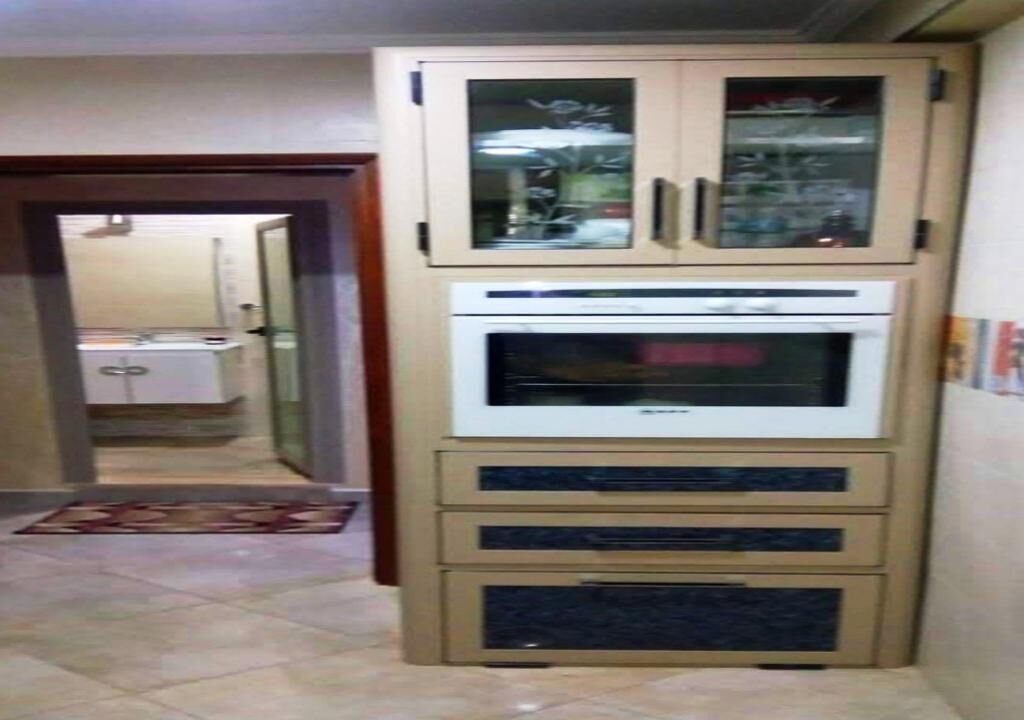 Una cocina con horno empotrado y armarios.