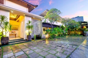 Enter a serene oasis with a lush garden and contemporary architecture.