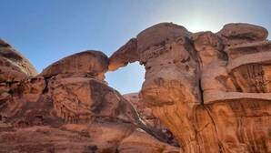 A natural rock formation with a prominent arch.