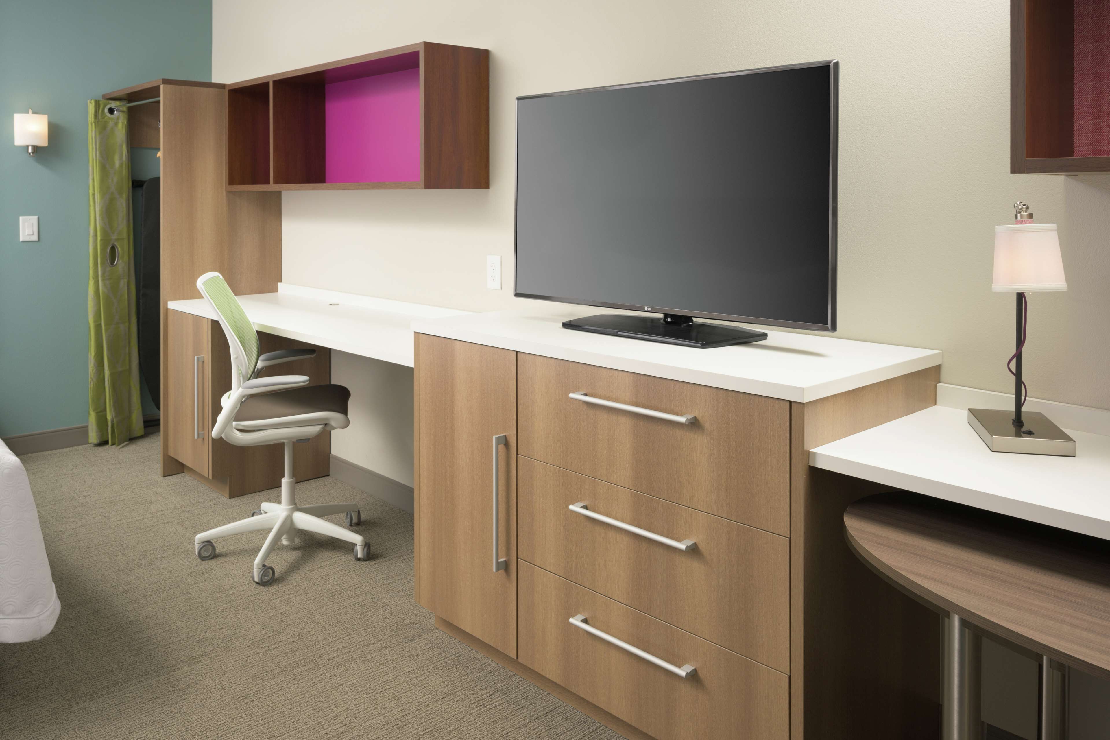 desk, laptop workspace, iron/ironing board, bed sheets