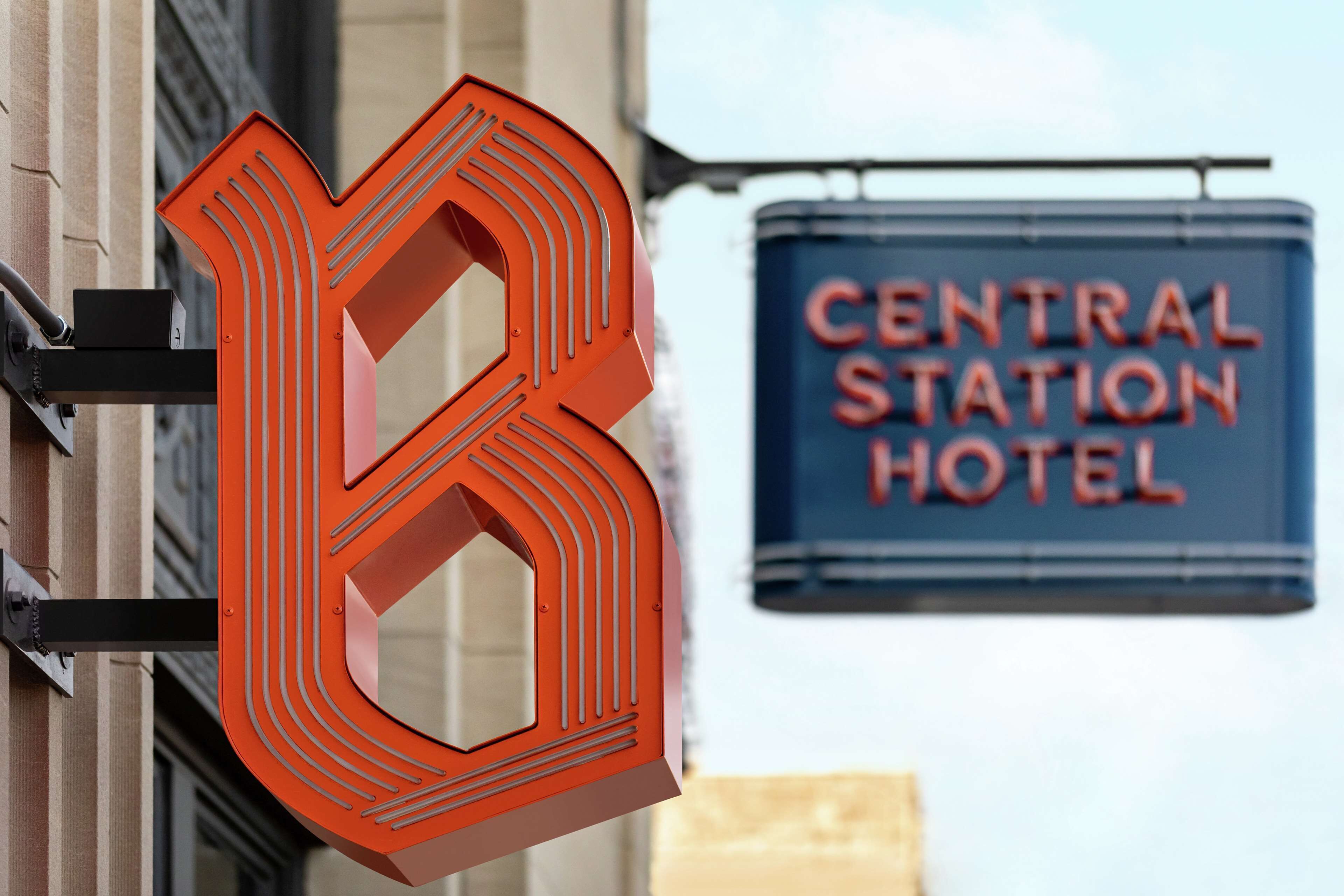 A large, bold '8' sign and a 'Central Station Hotel' sign in the background.
