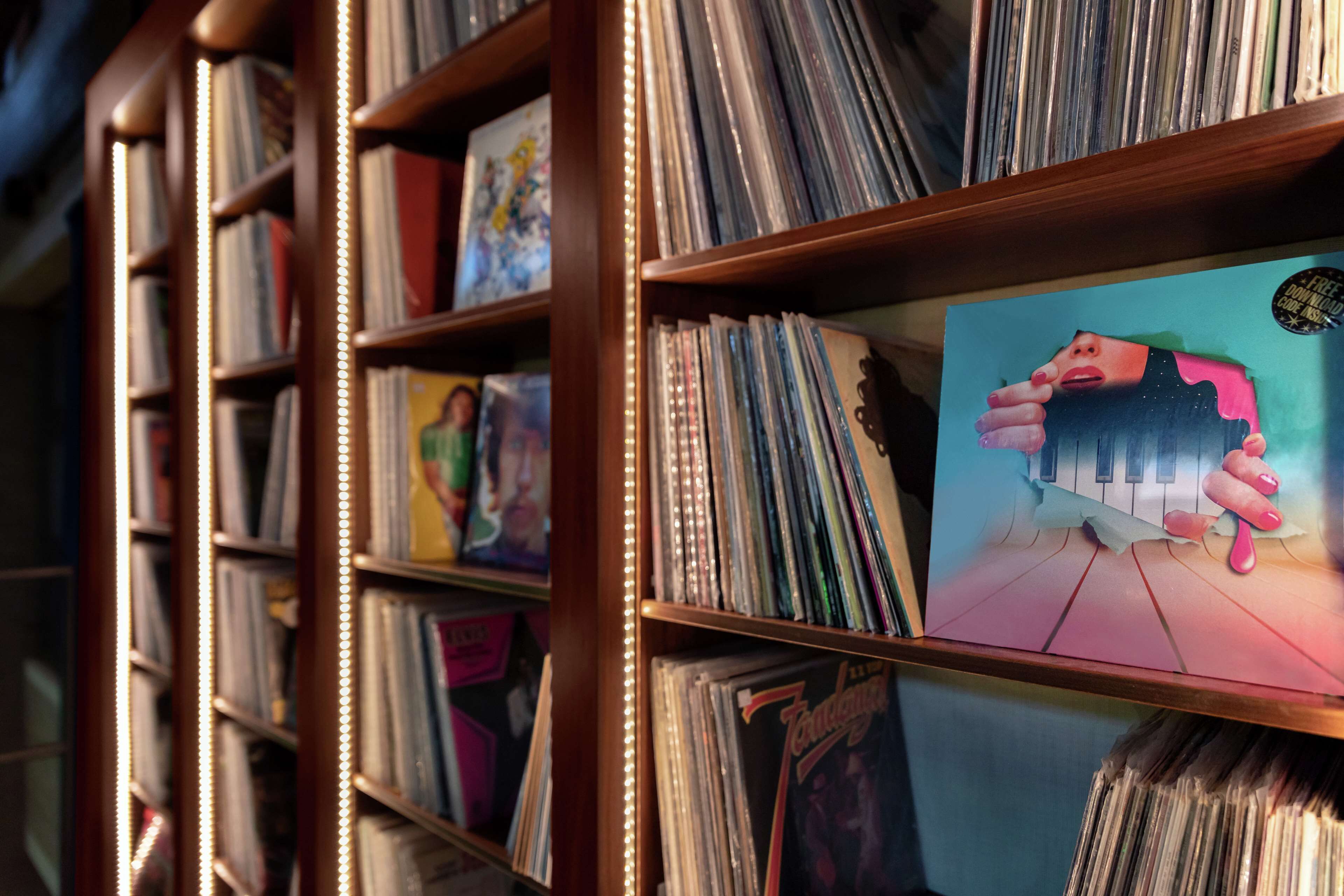 A section of a library with bookshelves filled with vinyl records.