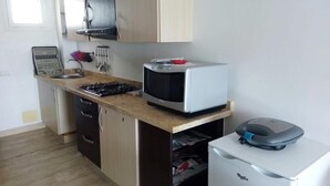 A compact kitchen with a microwave, a small refrigerator, and a sink. - Beautiful Studio in Playa Del Pacha 4429 (Mdiq)
