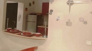 A bathroom with a red sink, a mirror, and a white toilet. - Apartment in Bouznika 4287 (Bouznika)