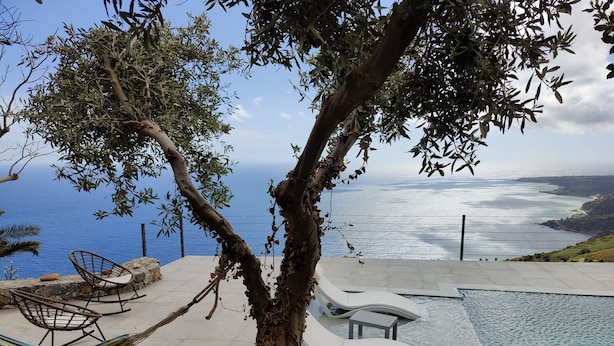 A pool area with a view of the sea, a hammock, and a cat walking by. - Private swimming pool, amazing views, sleeps 6. (Rethymno)