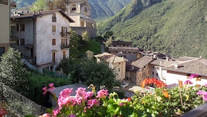 A mountainous village with traditional buildings, a church, and lush greenery. - Directly on the lake (Crone)