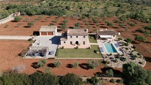 A villa with a swimming pool, a covered patio, and a view of the surrounding countryside. - Finca Sa Pletassa, Villa with Private Pool (Horta, S' (Felanitx))