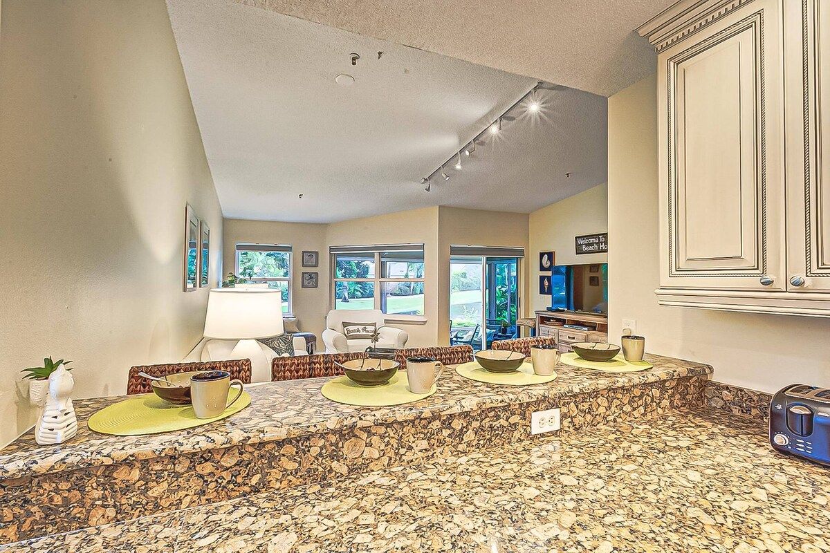 A kitchen with a granite countertop, a coffee maker, and a toaster.