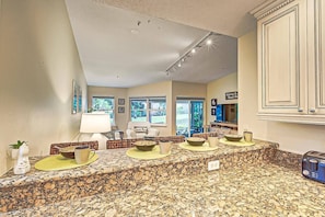 A kitchen with a granite countertop, a coffee maker, and a toaster.