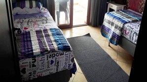 A hotel room with two beds, a desk, and a view of the outside. - Beautiful apartment in Lilacs Garden 4539 (Cabo Negro)