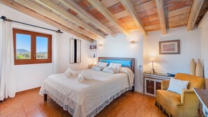 A bedroom with a large bed, a wooden ceiling, a window with curtains, a bedside table, and a chair. - LES MURTERETES   ref. VP79 (Pollensa / Pollença)